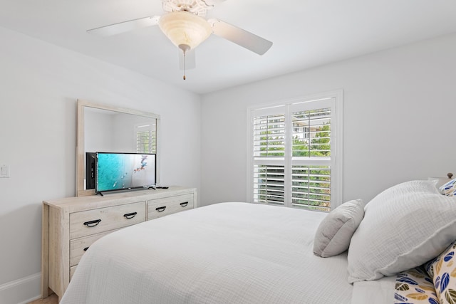 bedroom featuring ceiling fan and baseboards