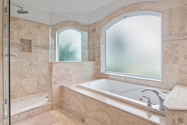 full bathroom featuring a shower stall and a tub with jets