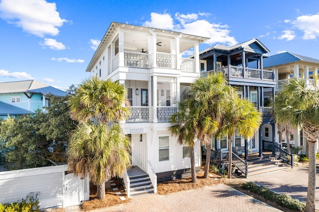 raised beach house with ceiling fan and a balcony