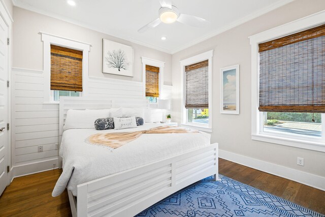 bedroom with dark wood-type flooring, ornamental molding, and ceiling fan