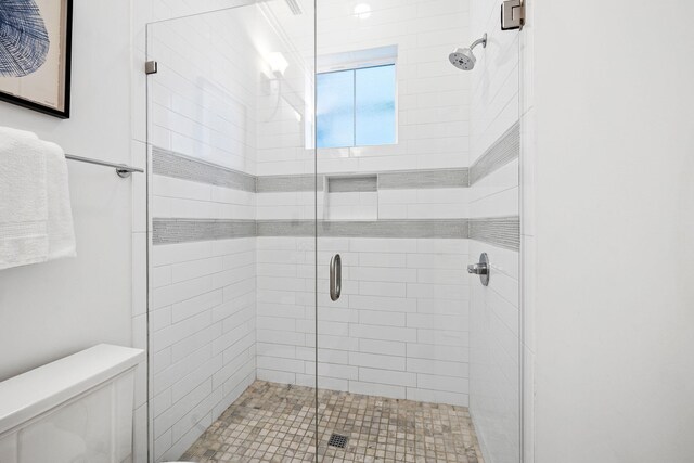 bathroom featuring toilet and walk in shower