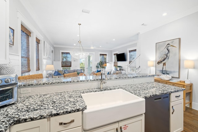 kitchen featuring sink, dark wood-type flooring, ornamental molding, and white cabinets