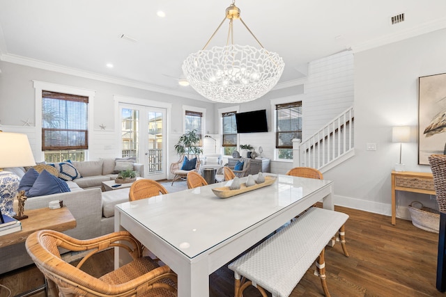 dining area with dark hardwood / wood-style flooring, ornamental molding, and a chandelier