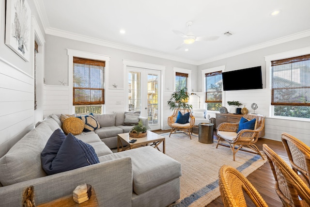 living room with hardwood / wood-style flooring, ornamental molding, and ceiling fan