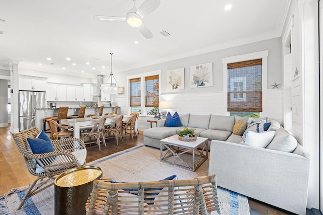 living room featuring ceiling fan, ornamental molding, hardwood / wood-style floors, and a wealth of natural light