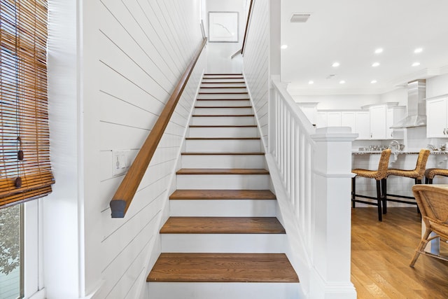 stairs with hardwood / wood-style floors