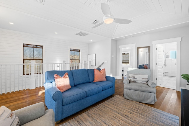 living room featuring dark hardwood / wood-style flooring, vaulted ceiling, and wooden ceiling