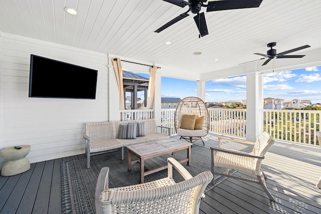 deck with outdoor lounge area and ceiling fan