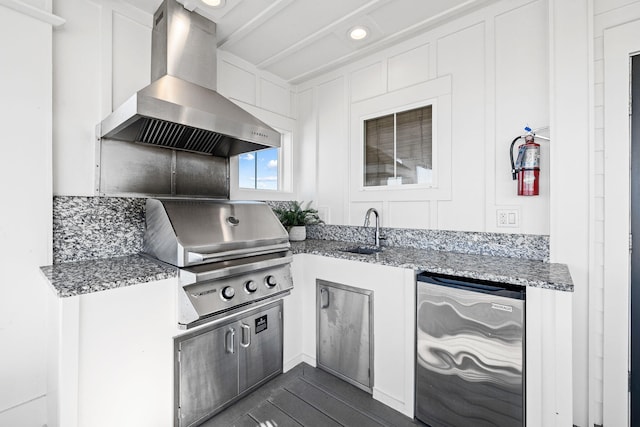 kitchen featuring sink, refrigerator, white cabinetry, light stone counters, and extractor fan