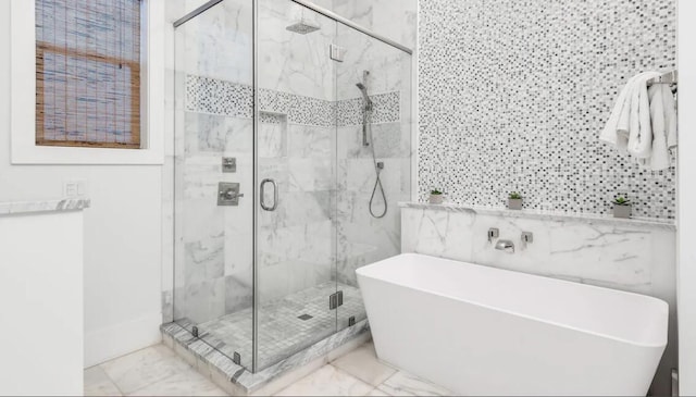 bathroom featuring plus walk in shower and tile walls