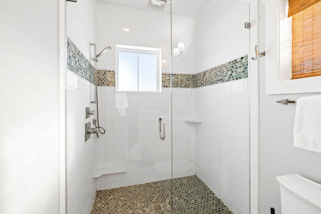 bathroom with walk in shower and toilet