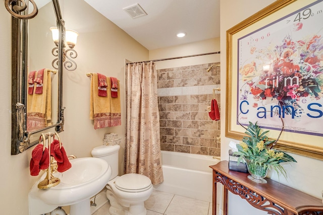 full bathroom with tile patterned flooring, toilet, sink, and shower / bath combo with shower curtain