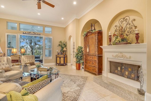 living room with crown molding, ceiling fan, and light tile patterned flooring