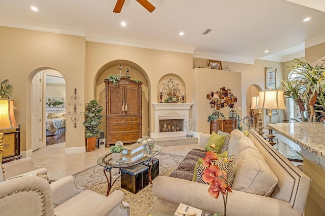 tiled living room with crown molding and ceiling fan