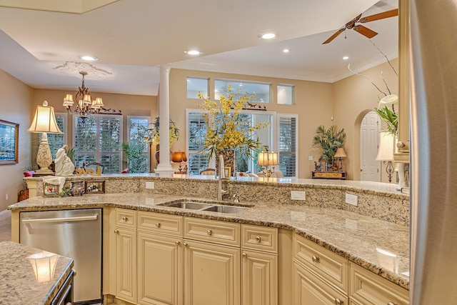 kitchen featuring sink, dishwasher, light stone countertops, ceiling fan with notable chandelier, and cream cabinetry