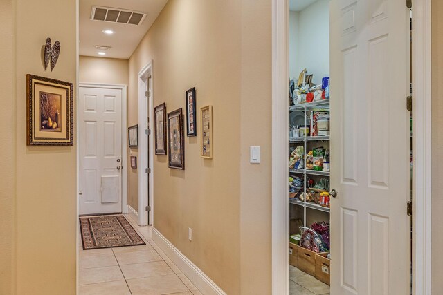 hall featuring light tile patterned floors