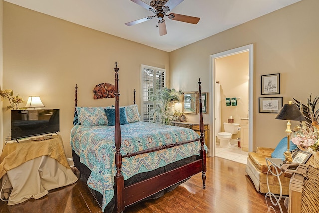 bedroom featuring hardwood / wood-style floors, ceiling fan, and ensuite bathroom