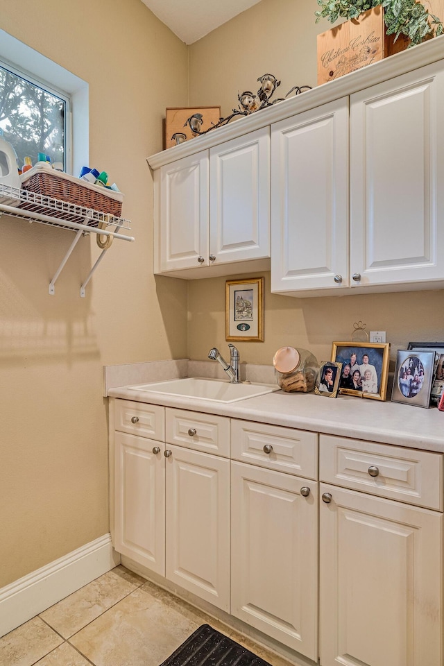 laundry area with sink and light tile patterned floors