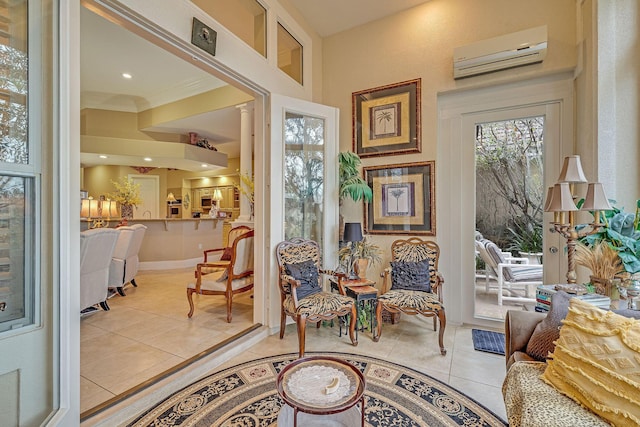 living area featuring crown molding, a wall mounted air conditioner, and light tile patterned floors