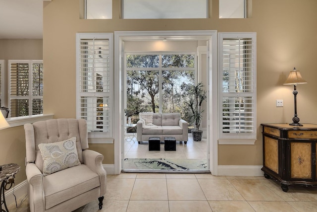 sitting room with light tile patterned floors and baseboards