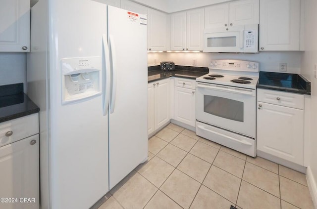 kitchen with white cabinetry, light tile patterned floors, and white appliances