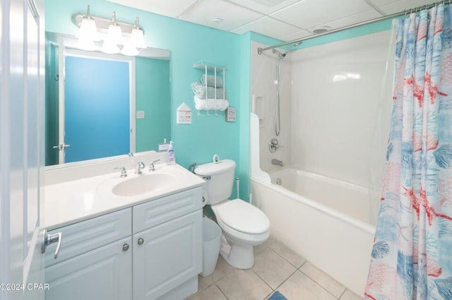 full bathroom featuring tile patterned floors, toilet, vanity, shower / bath combo, and a drop ceiling