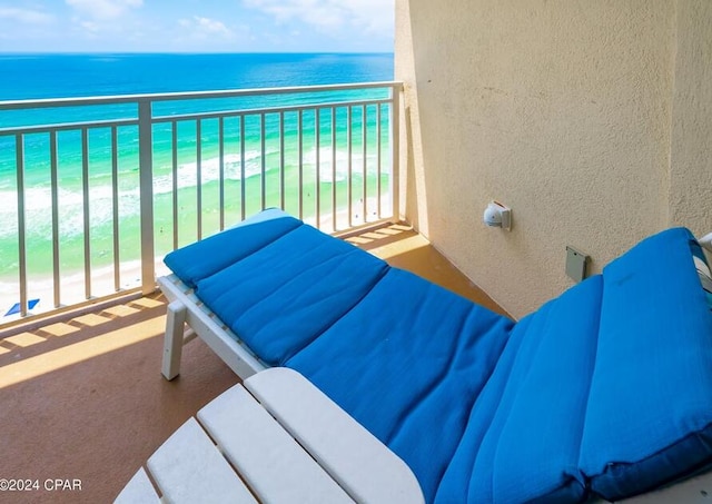 balcony with a water view and a beach view