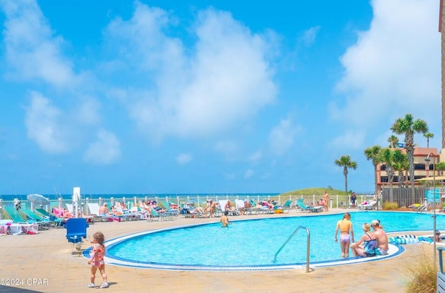 view of swimming pool with a water view