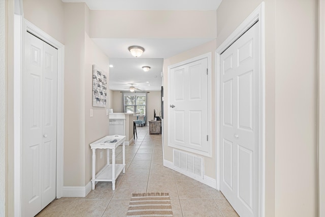 corridor with light tile patterned floors