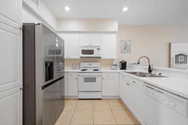 kitchen featuring white cabinetry, sink, light tile patterned flooring, and white appliances