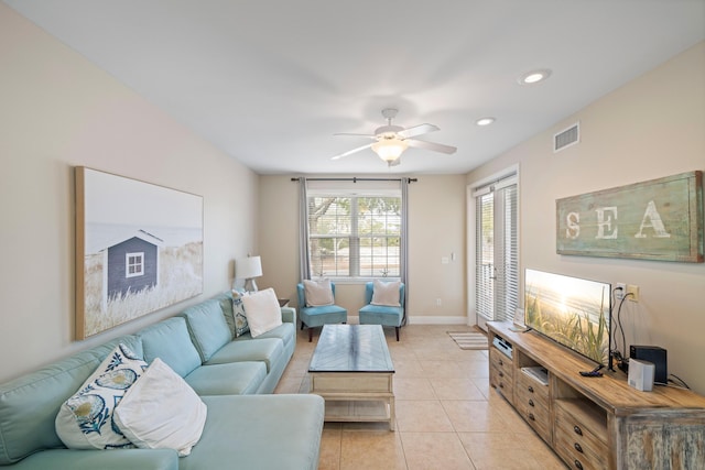 living room featuring light tile patterned floors and ceiling fan