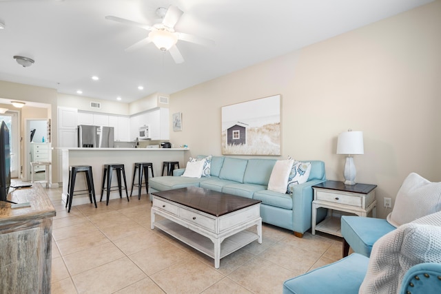 tiled living room featuring ceiling fan