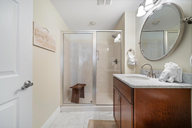 bathroom with walk in shower and vanity