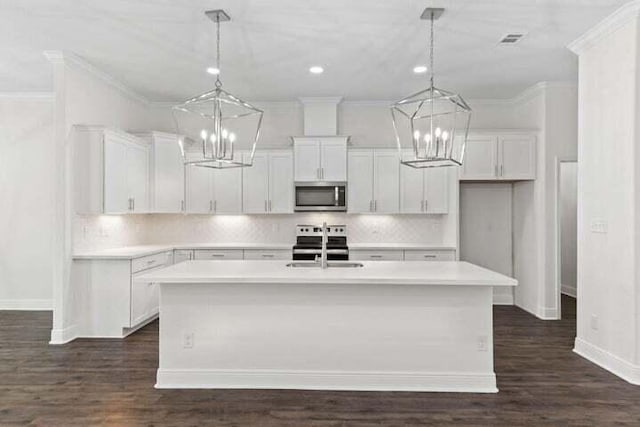 kitchen featuring white cabinetry and an island with sink