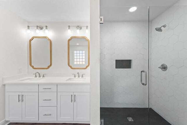 bathroom featuring vanity and a shower with shower door