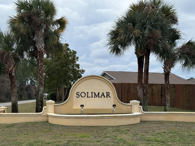 community / neighborhood sign with a lawn