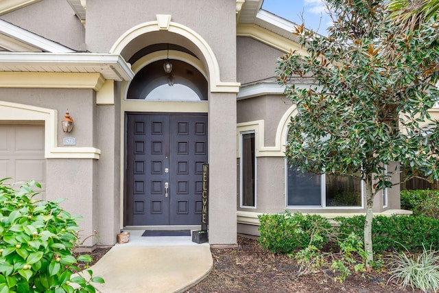 view of exterior entry with a garage