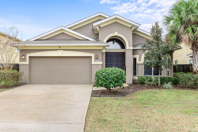 view of front of property featuring a garage and a front yard