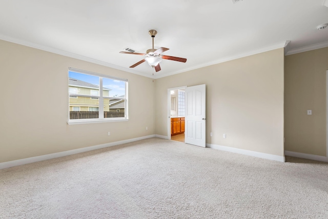 spare room featuring ornamental molding, light colored carpet, and ceiling fan