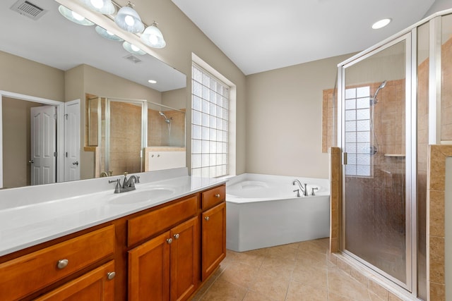 bathroom featuring vanity, tile patterned floors, and plus walk in shower