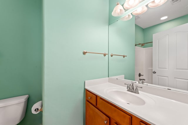 bathroom featuring vanity, toilet, and a shower