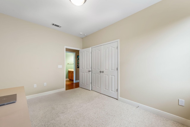 unfurnished bedroom with carpet floors and a closet