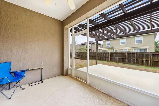 sunroom featuring ceiling fan