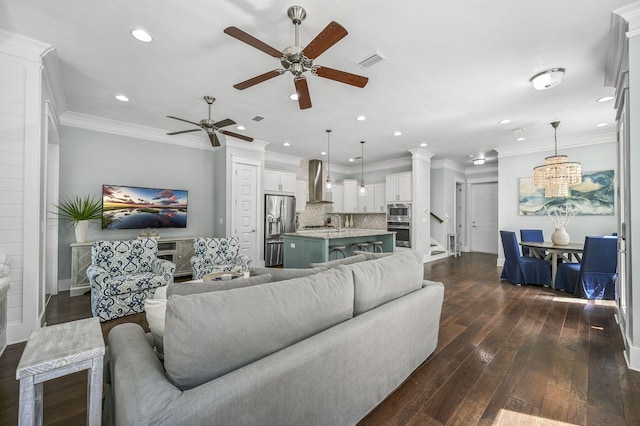 living room featuring crown molding, dark hardwood / wood-style floors, and ceiling fan