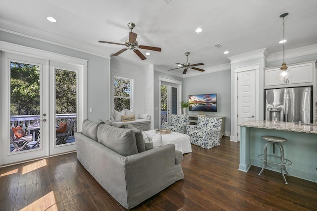 living room with dark hardwood / wood-style flooring and crown molding