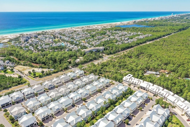 birds eye view of property with a water view and a beach view