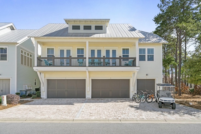 raised beach house with a balcony and a garage