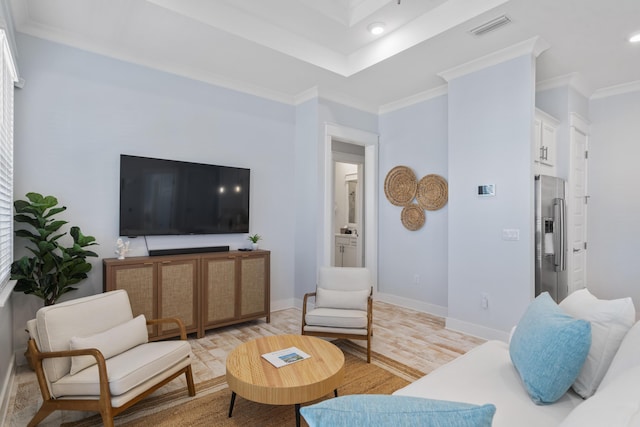 living room featuring ornamental molding and light wood-type flooring