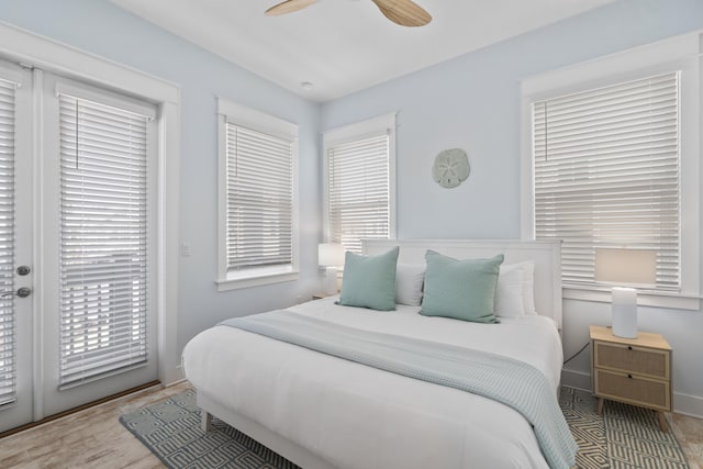 bedroom with access to exterior, light hardwood / wood-style floors, and ceiling fan