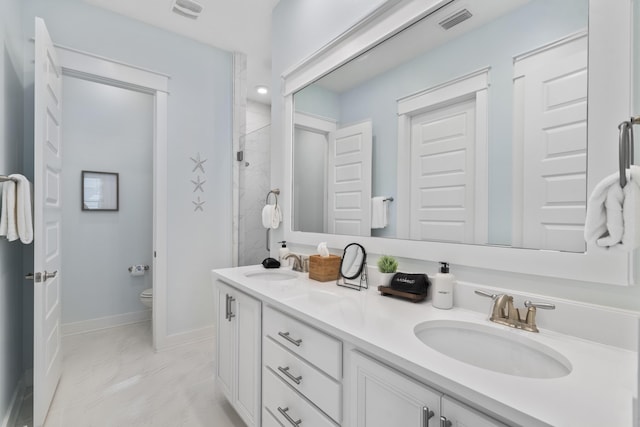 bathroom with vanity, an enclosed shower, and toilet